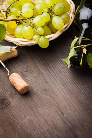 White grapes, corkscrew, cork and bottle with copyspaceの写真素材