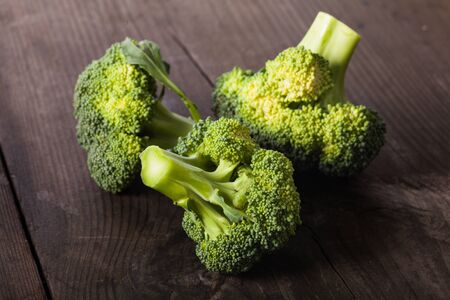 Green broccoli on the wood background closeupの写真素材