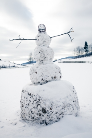 A snowman in the yard in village closeupの写真素材