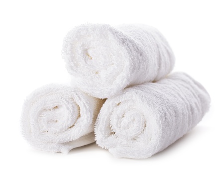 White spa towels pile isolated on white backgroundの写真素材