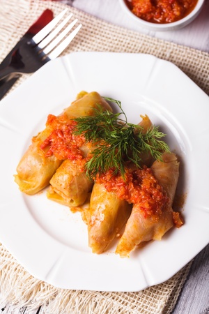 Stuffed cabbage with tomato dip on the plateの写真素材
