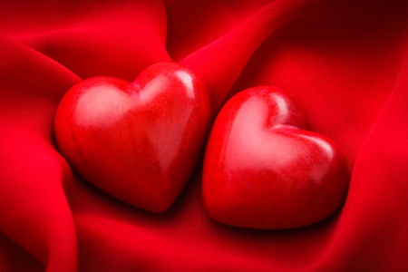 Two valentine hearts on red textile. Valentine's day conceptの写真素材