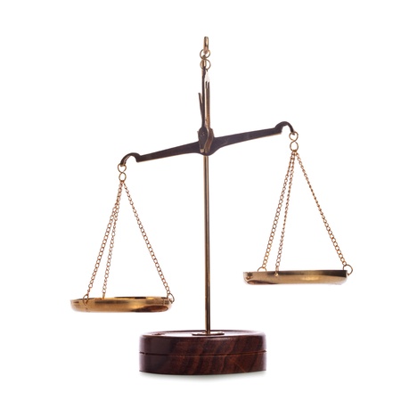 Unbalanced golden vintage scales isolated on whiteの写真素材