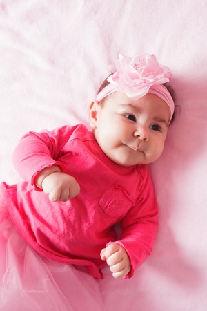 Three month old baby girl in pink tutuの写真素材
