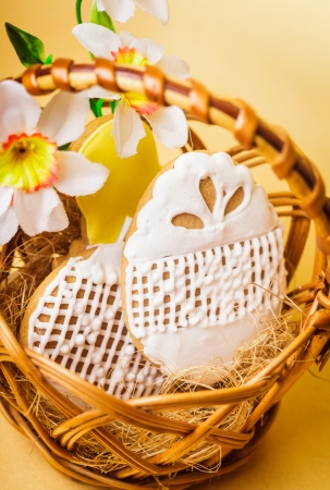 Easter cookies in basket over yellow background. Easter decorの写真素材