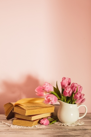 Poem still life with books and pink tulips with copy space. Teacher's day.の写真素材