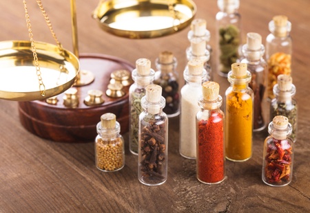 Little bottles with spices and scales on the table, vedic cuisineの写真素材