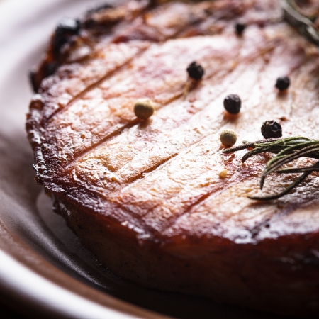 Meat steak roasted on grill with spices on the plateの写真素材