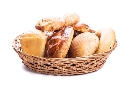 Different types of breads and buns in the basket on a whiteの写真素材