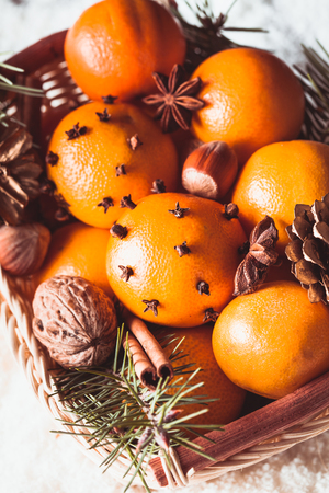 Christmas basket - fir, tangerins and spices on the snowの写真素材