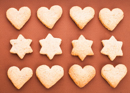 Holiday cookies as a background pattern on brownの写真素材