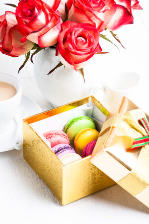 macaroon in gift box and roses in vaseの写真素材