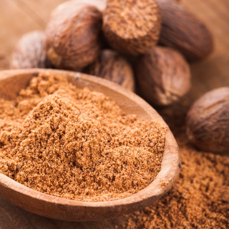 Ground nutmeg spice in the wooden spoon closeupの写真素材