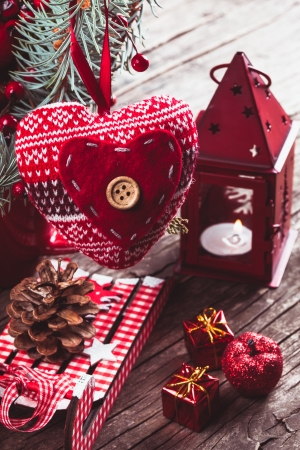 Christmas decorations: heart, candlestick and sleds on old wooden tableの写真素材