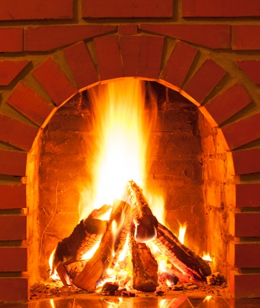 Burning fire in the brick fireplace, close upの写真素材