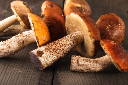 Orange-cap boletus mushrooms on the wooden tableの写真素材