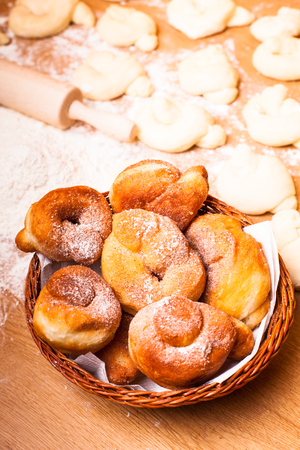 Fresh donats with sugar powder and prepared doughの写真素材