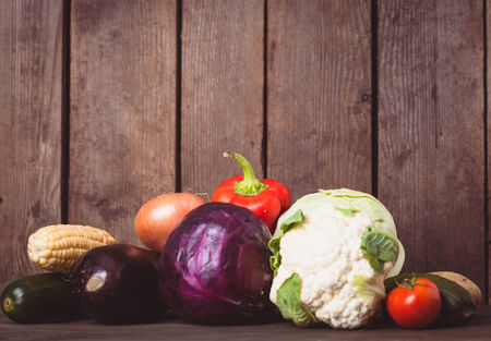 Still life of vegetables on the wood background closeup