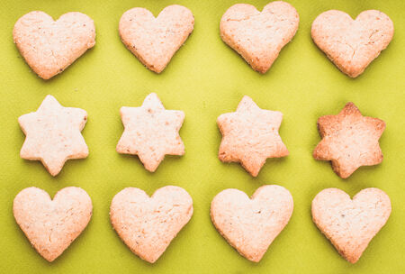 Holiday cookies as a background pattern on greenの写真素材
