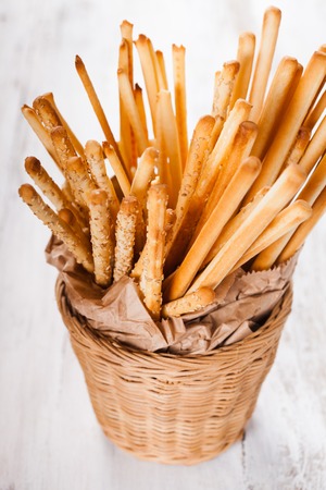 Different types of grissini breadsticks in a basket