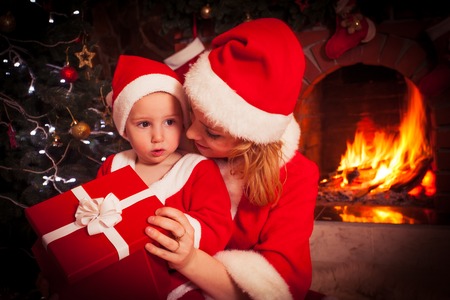 Mother and son near Christmas fireplaceの写真素材