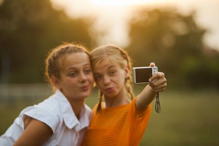 happy Girl Friends taking selfieの写真素材