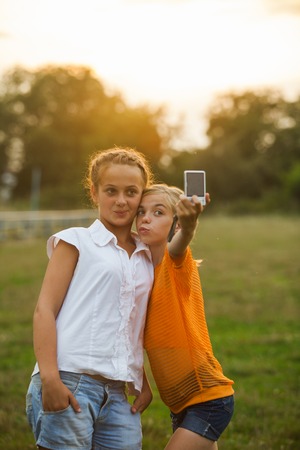 happy Girl Friends taking selfieの写真素材