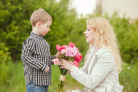 Mother get flowers from her sonの写真素材