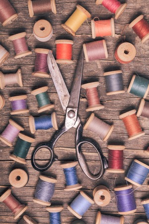 Retro wooden sewing spools with scissorsの写真素材