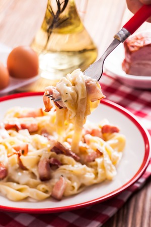 Italiatn traditional cuisine - pasta tagliatelle carbonara on a plateの写真素材
