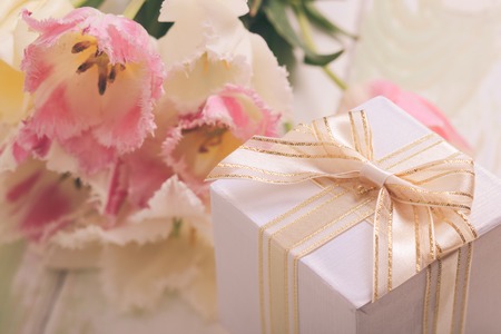 Box with present and tulips for momの写真素材