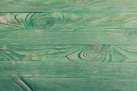 Green wooden wall, painted in shabby chic style