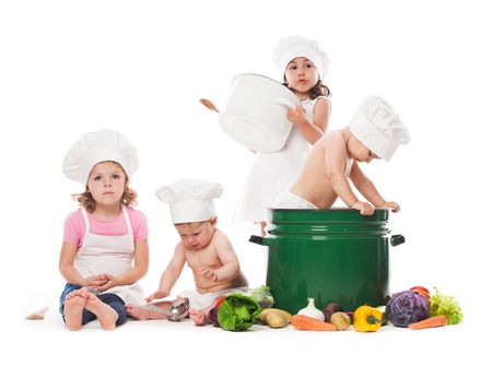 Four kids play with vegetables and kitchenware, cooking the soupの写真素材