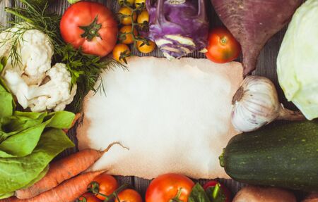 Old recipe on the table with vegetables with copy spaceの写真素材