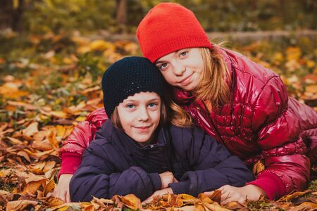 Two friendly sisters playing in autumn and smilingの写真素材
