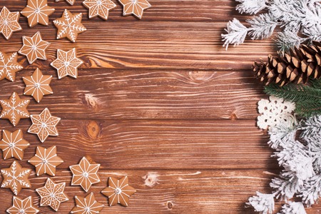 Frame of gingerbreads on a wooden background.