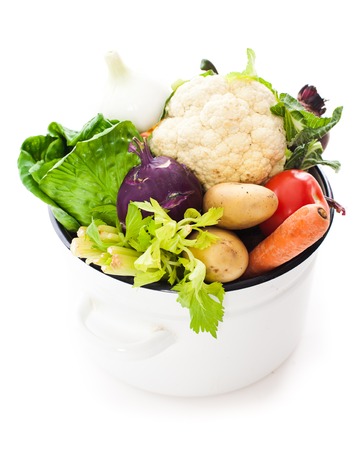 Vegetables for soup in the saucepan isolated on whiteの写真素材