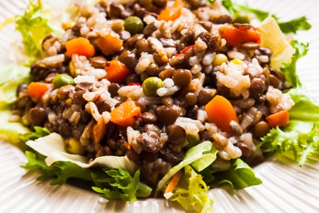 Salad with vegetables, rice and lentils on a plateの写真素材
