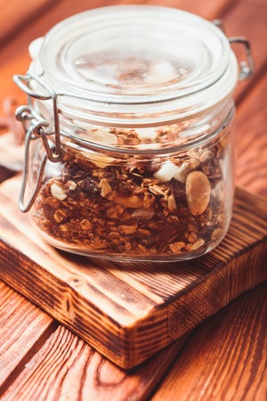 Granola in a jar on the wooden table close upの写真素材