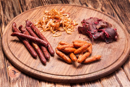 Snacks for beer - pork ears,  sausages and basturmaの写真素材