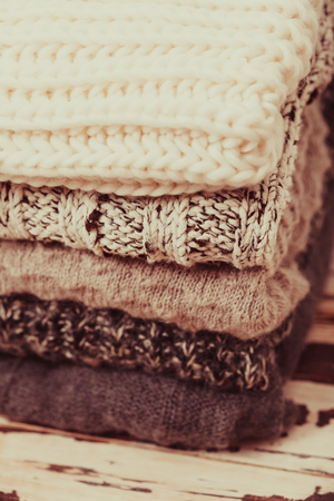Stack warm knitted sweaters in white and gray shadesの写真素材