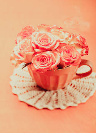 Bouquet of beautiful fresh pink roses in pink cupの写真素材