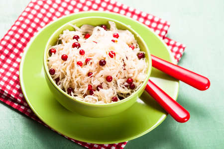 sauerkraut with cranberry in a green bowlの写真素材