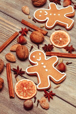 Gingerbreads with spices on the wooden table. Christmas aroma decor