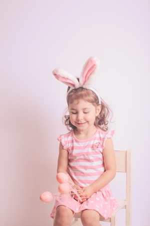Girl with little pink eggs for the Easter huntingの写真素材