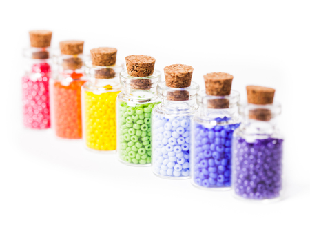 Beads in the vintage mini glass bottles with corks isolated on whiteの写真素材