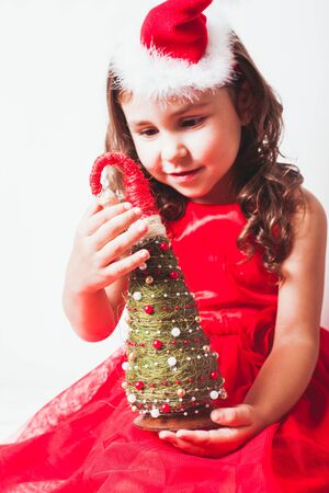 Girl holds in her hands handmade decor - Christmas tree from sisal and beadsの写真素材