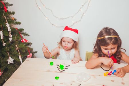 Two beautiful girls  painted wooden Christmas figurinesの写真素材