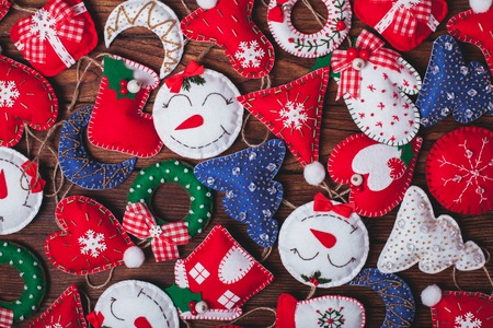 felt Christmas decorations on the wooden table as a backgroundの写真素材