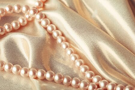 Background from beads on the silk textileの写真素材